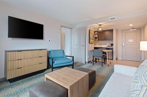 a living room with a couch and a tv at Homewood Suites by Hilton St Augustine San Sebastian in Saint Augustine