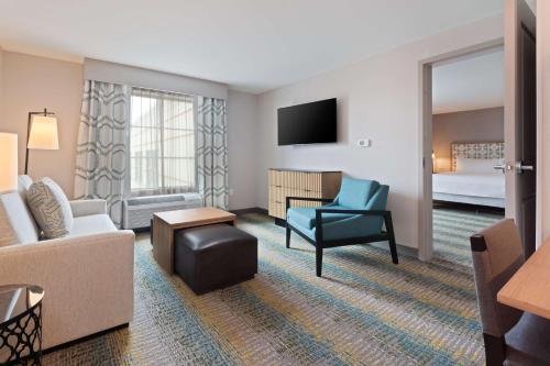 a hotel room with a couch and a bed at Homewood Suites by Hilton St Augustine San Sebastian in Saint Augustine
