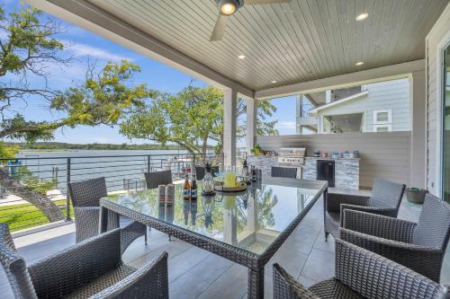 an outdoor patio with a glass table and chairs at Rolling Waves Haven Concierge Services Available in Kingsland