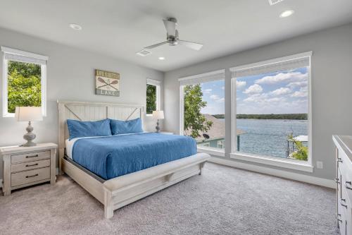 a bedroom with a bed and a view of the water at Rolling Waves Haven Concierge Services Available in Kingsland