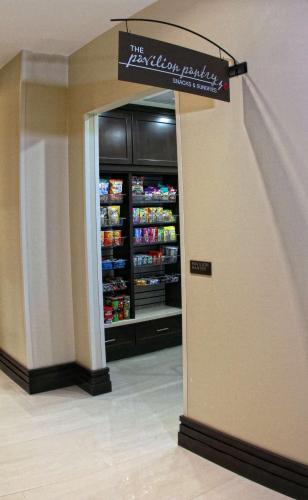 a grocery store aisle with a refrigerator with drinks at Hilton Garden Inn Victoria in Victoria