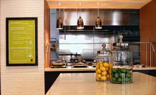 a kitchen with a counter with fruits and food at Hilton Garden Inn Victoria in Victoria