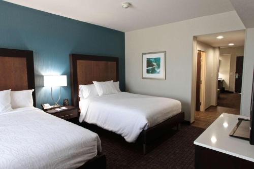 a hotel room with two beds and a bathroom at Hilton Garden Inn Victoria in Victoria