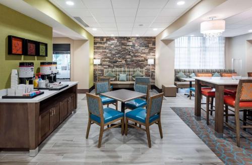 a waiting room at a hospital with tables and chairs at Hampton Inn Baltimore Bayview Campus in Baltimore