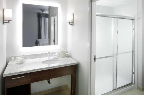 a bathroom with a sink and a mirror at Homewood Suites by Hilton Chattanooga - Hamilton Place in Chattanooga