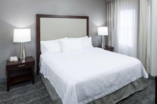 a large bed in a hotel room with two lamps at Homewood Suites by Hilton Chattanooga - Hamilton Place in Chattanooga