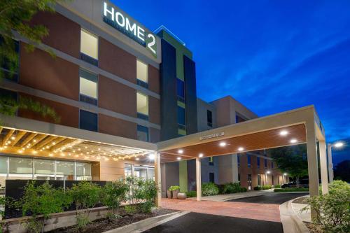 un edificio de hotel con una entrada iluminada por la noche en Home2 Suites by Hilton Lexington Park Patuxent River NAS, MD, en Lexington Park