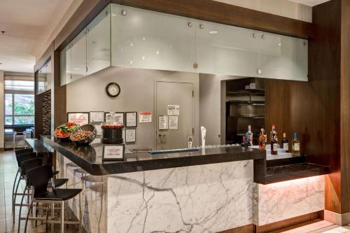 a kitchen with a bar with a counter top at Embassy Suites Chicago - Downtown River North in Chicago