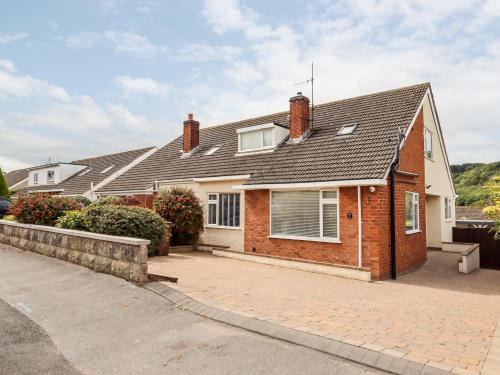 a brick house with a roof on a street at 4 Bodnant Road in Colwyn Bay