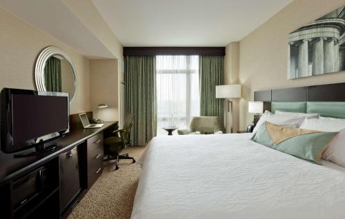 a hotel room with a bed and a flat screen tv at Hilton Garden Inn Washington D.C./U.S. Capitol in Washington