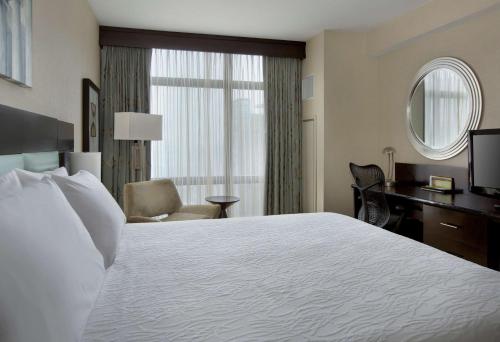 a hotel room with a large bed and a desk at Hilton Garden Inn Washington D.C./U.S. Capitol in Washington