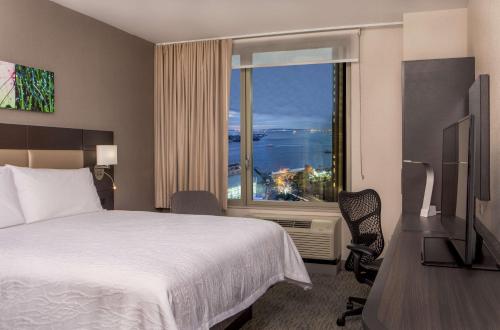 a hotel room with a bed and a large window at Hilton Garden Inn NYC Financial Center/Manhattan Downtown in New York