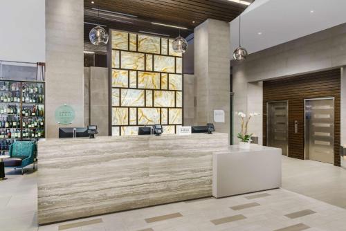 a lobby with a reception desk in a building at Hilton Garden Inn New York Times Square North in New York