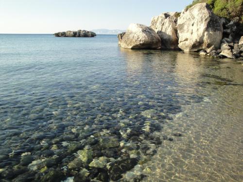 a body of water with rocks in the water at B&B Bella Vista in Dorgali
