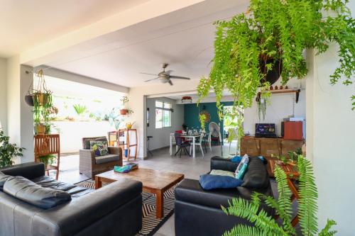 a living room with two couches and a table at Villa Bô Soley, côté Plages et Volcan in Le Prêcheur