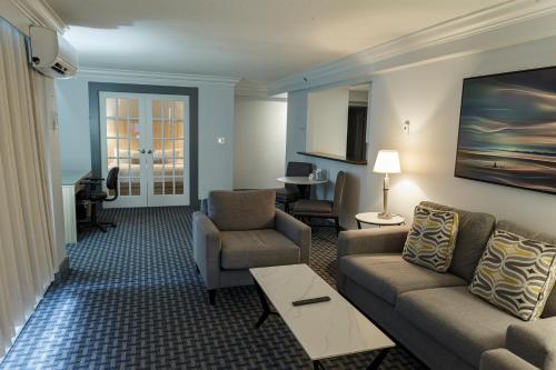 a living room with a couch and chairs and a table at Century Plaza Hotel in Vancouver