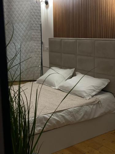 a bed with white sheets and pillows in a room at Loft inn in Makhunts'et'i