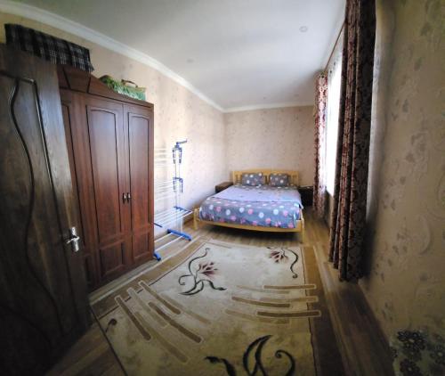a bedroom with a bed in the corner of a room at Апартаменты in Tashkent