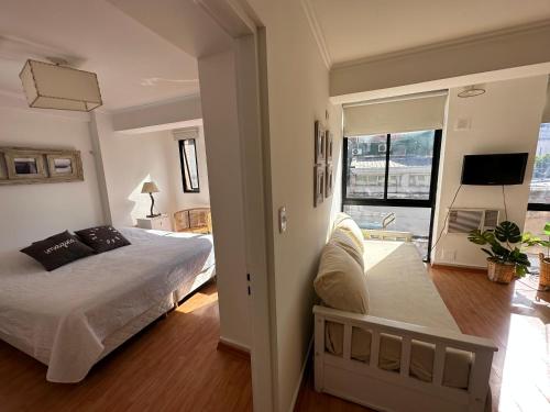 a bedroom with a bed and a large window at apart las piedras 2 in San Miguel de Tucumán