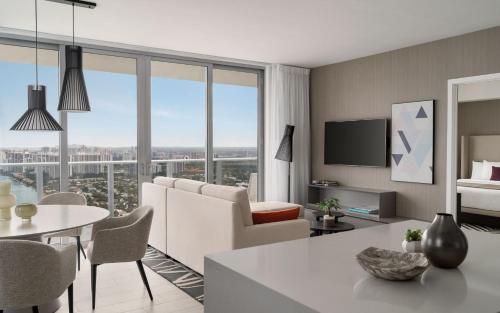 a living room with a couch and a table at Top Notch 3 BR Suite At Hyde Beach House - 5✩ Amenities in Hollywood