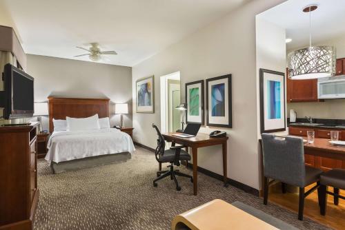 a hotel room with a bed and a desk at Homewood Suites by Hilton Birmingham South Inverness in Hoover