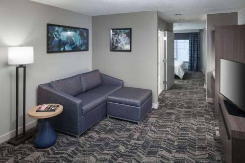 a living room with a couch and a tv at Hilton Garden Inn Hilton Head in Hilton Head Island