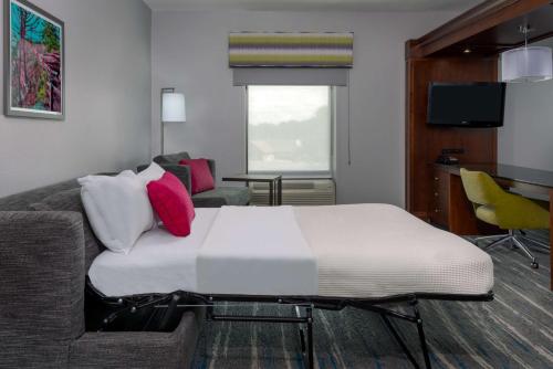 a large bed in a living room with a couch at Hampton Inn & Suites Winston-Salem/University Area in Winston-Salem