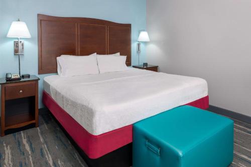 a hotel room with a bed and a blue stool at Hampton Inn & Suites Winston-Salem/University Area in Winston-Salem