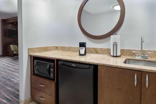 a kitchen with a sink and a mirror at Hampton Inn & Suites Winston-Salem/University Area in Winston-Salem