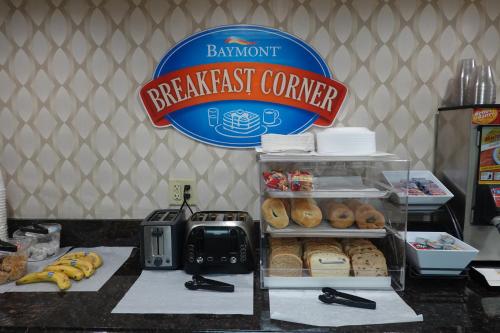 a breakfast counter with a breakfast corner sign in a bakery at Baymont by Wyndham Janesville in Janesville