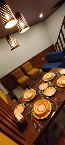 a dining room table with orange plates on it at Casa Ayacucho in Sucre