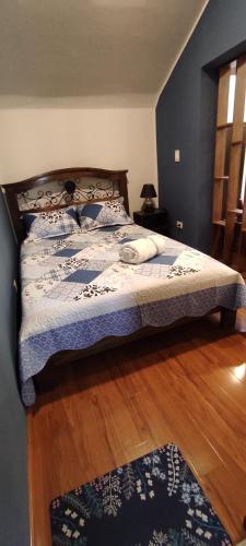 a bedroom with a bed and a wooden floor at Casa Ayacucho in Sucre