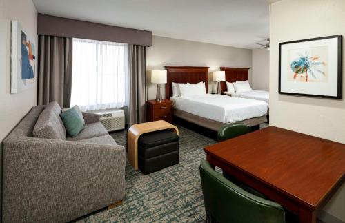 a hotel room with a couch and a bed and a desk at Homewood Suites by Hilton Jacksonville-South/St. Johns Ctr. in Jacksonville