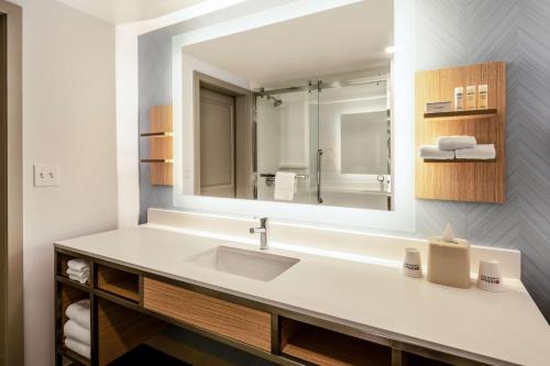a bathroom with a sink and a mirror at Hilton Garden Inn Jacksonville/Ponte Vedra in Ponte Vedra Beach