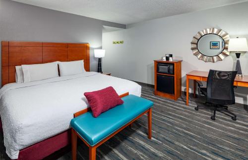 a hotel room with a bed and a desk at Hampton Inn & Suites Mobile I-65@ Airport Boulevard in Mobile