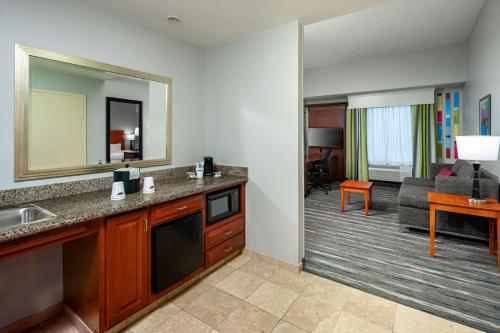 a hotel room with a kitchen and a living room at Hampton Inn & Suites Mobile I-65@ Airport Boulevard in Mobile