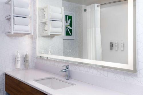 a white bathroom with a sink and a mirror at Hampton Inn Savannah Historic District in Savannah