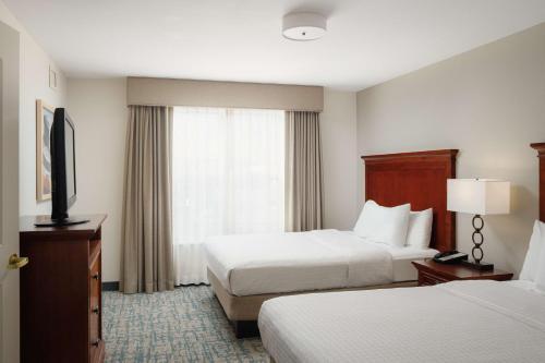 a hotel room with two beds and a window at Homewood Suites by Hilton Knoxville West at Turkey Creek in Knoxville