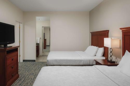 a hotel room with two beds and a flat screen tv at Homewood Suites by Hilton Knoxville West at Turkey Creek in Knoxville