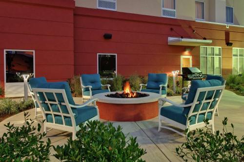 a patio with chairs and a fire pit in front of a building at Hampton Inn & Suites Knoxville-Turkey Creek Farragut in Knoxville