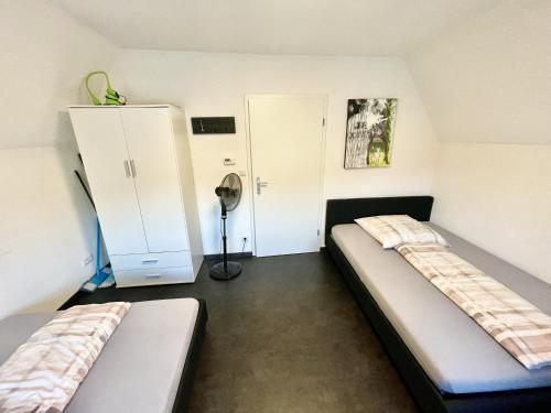 Habitación pequeña con 2 camas y armario. en Ferienwohnung Khorsandi Eins en Coburg