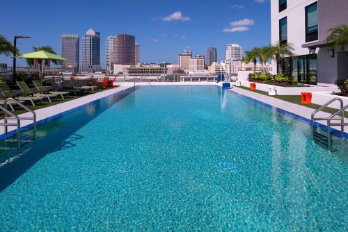 a large swimming pool with a city skyline in the background at Home2 Suites By Hilton Tampa Downtown Channel District in Tampa