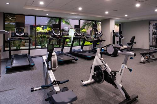 a gym with several treadmills and exercise bikes at Home2 Suites By Hilton Tampa Downtown Channel District in Tampa