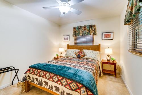 a bedroom with a bed and a ceiling fan at Quiet Murphy Hideaway with Decks and Outdoor Fireplace in Murphy