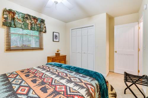 a bedroom with a bed and a window at Quiet Murphy Hideaway with Decks and Outdoor Fireplace in Murphy