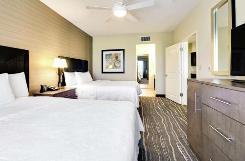 a hotel room with two beds and a flat screen tv at Homewood Suites by Hilton Dallas/Allen in Allen