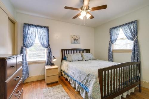 a bedroom with a crib and two windows at Fayetteville Vacation Rental about 6 Mi to Downtown! in Fayetteville