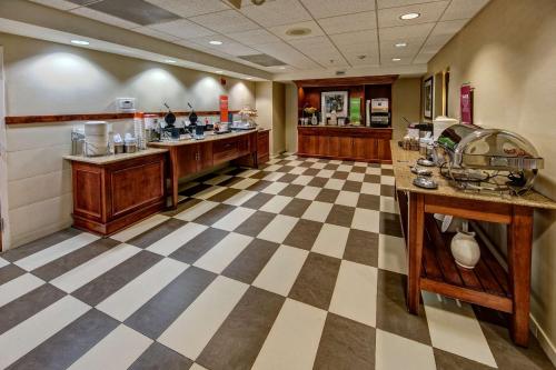 a lobby with a checkered floor and a bar at Hampton Inn Dunn in Dunn