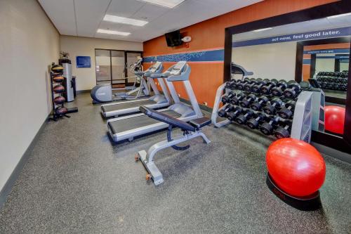 a gym with treadmills and dumbbells at Hampton Inn Dunn in Dunn