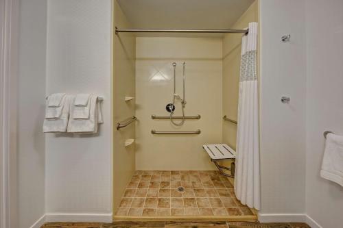 a small bathroom with a shower and a toilet at Hampton Inn Dunn in Dunn